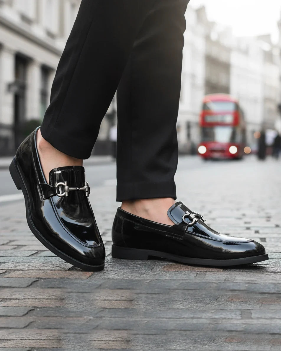 Man wearing black patent leather horsebit loafers with tailored trousers - street style