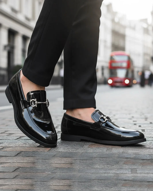 Man wearing black patent leather horsebit loafers with tailored trousers - street style
