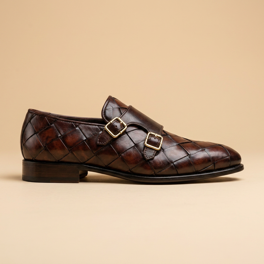 Close-up of intrecciato weave detail on brown leather monk strap loafers