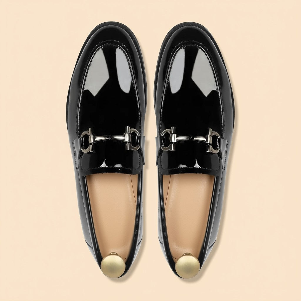 Pair of men's black patent leather horsebit loafers with silver buckle - top view